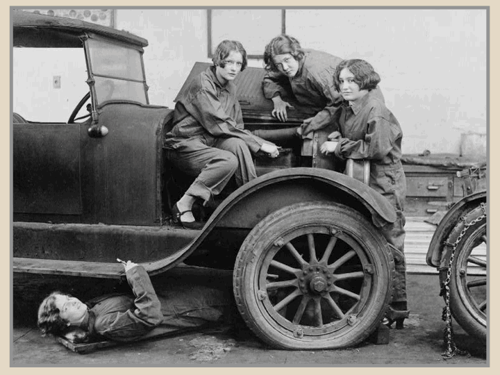 Postcard of high school girls working on a car 1927